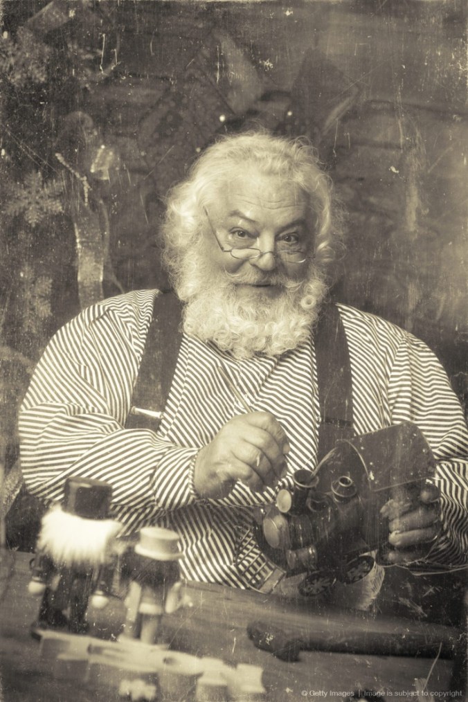 Vintage Santa Claus in his Workshop Making Toys